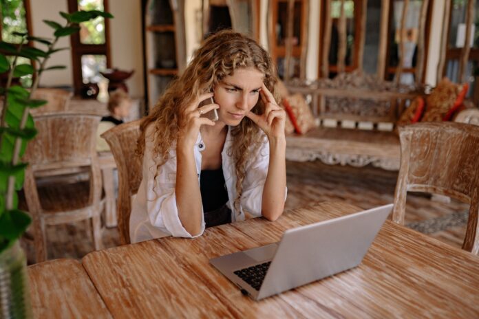 Photo of Woman Using Cellphone While Looking Serious